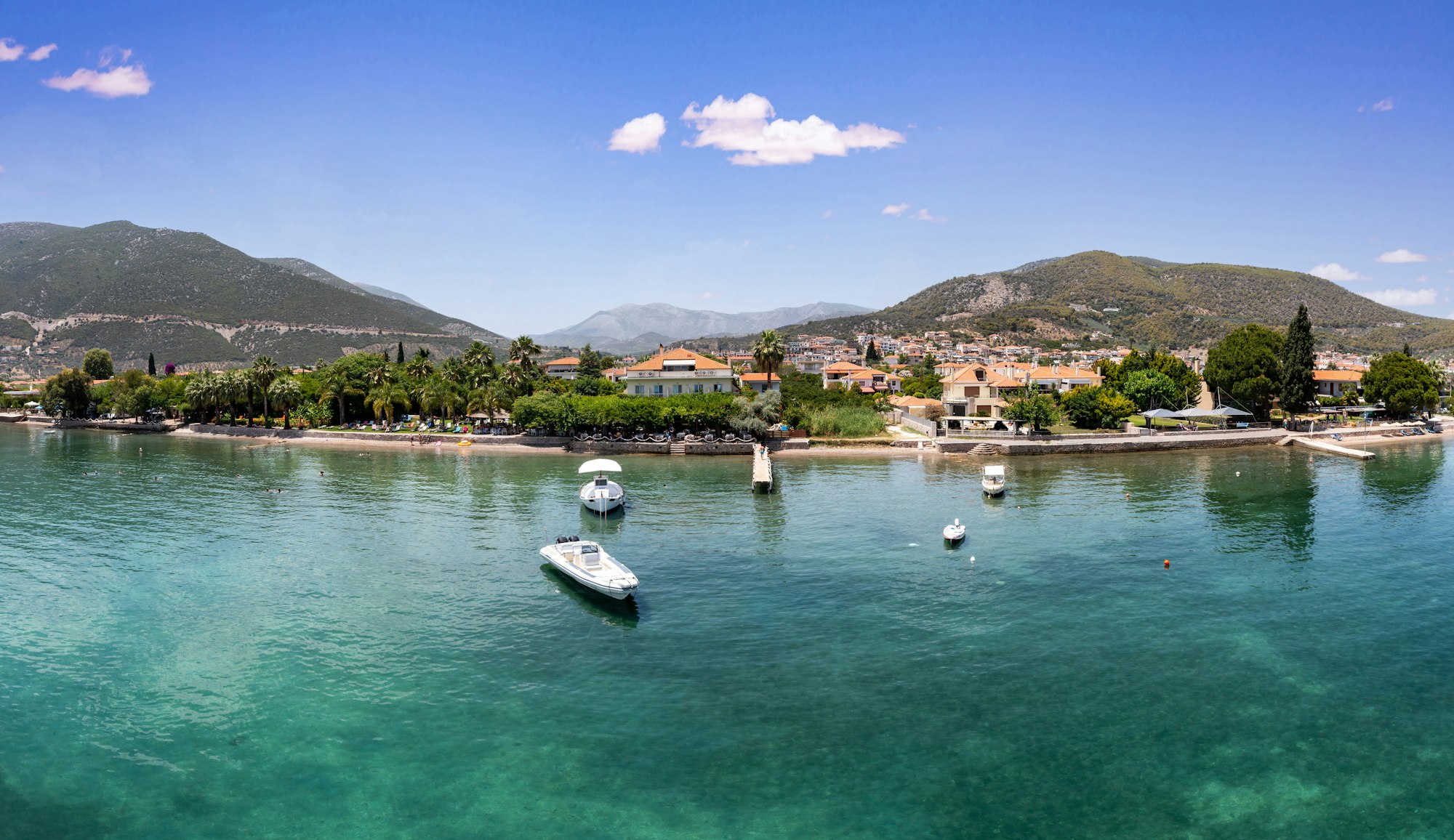 Aerial, drone view of Ancient Epidaurus town beach and port at Peloponnese, Greece.