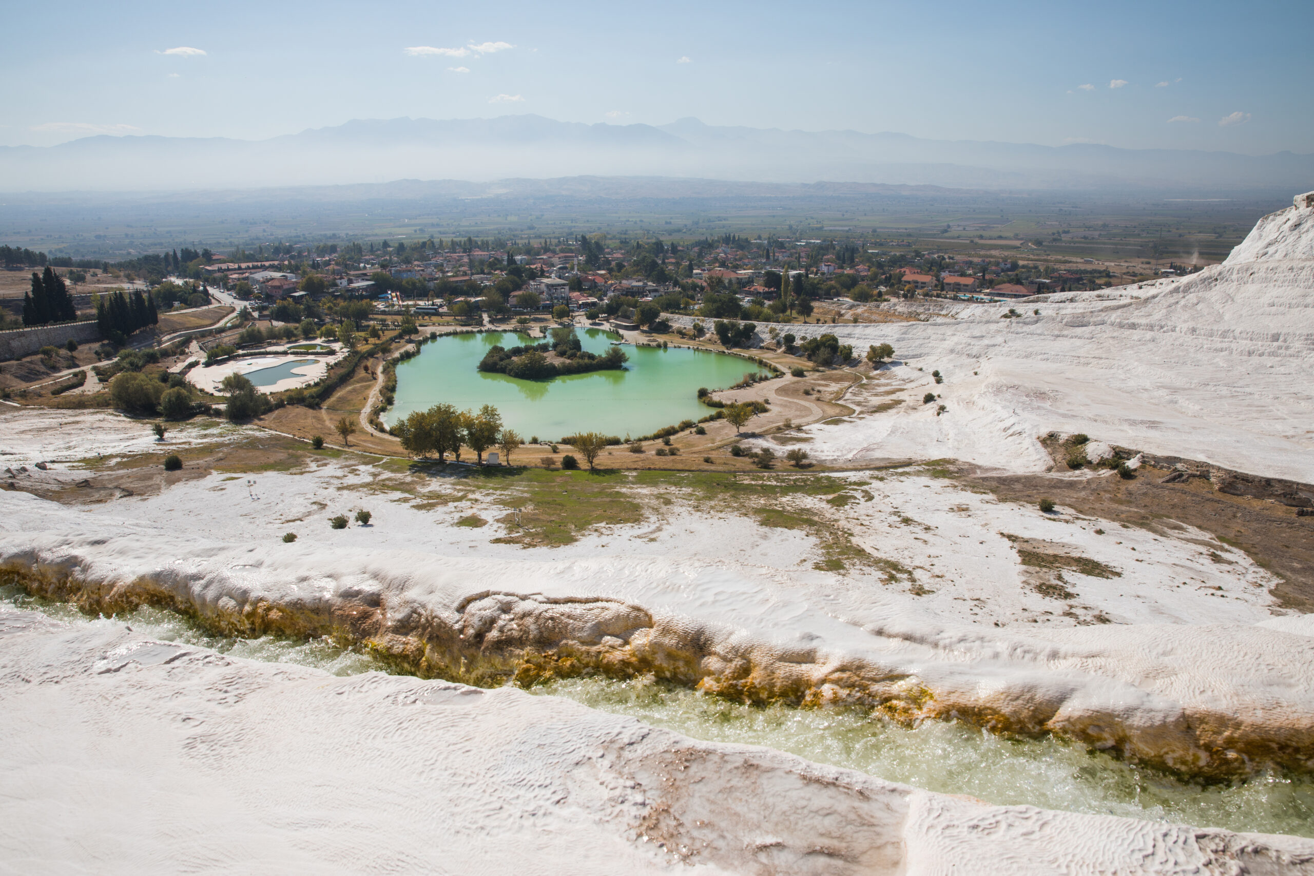 beautiful landscape with white rocks and pool in pamukkale, turkey