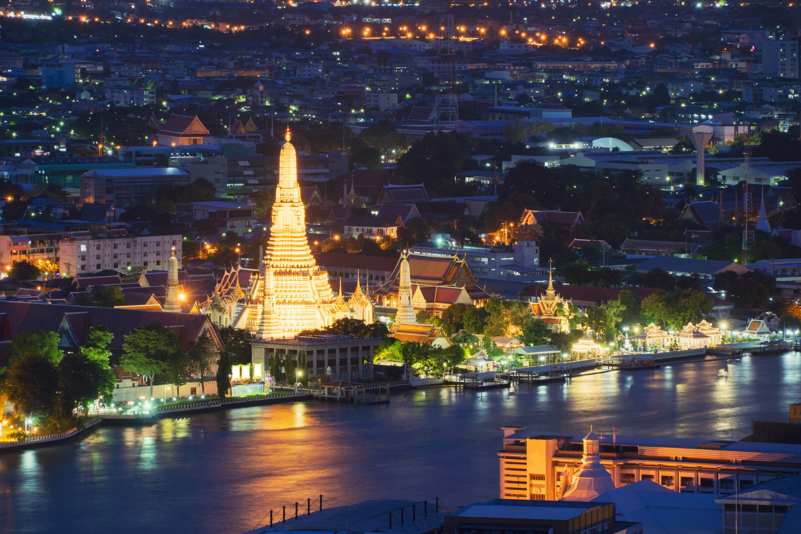 Temple of Dawn with Chao Phraya River at night in Bangkok City, Thailand. Buddhist temple.